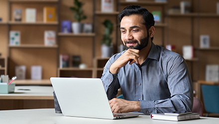 A person seated at a laptop